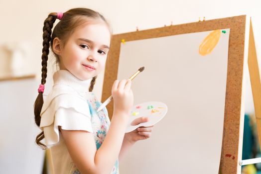 portrait of a girl standing next to his easel, a drawing lesson