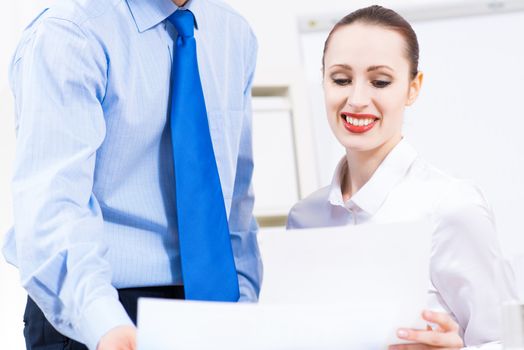 colleagues discuss the reports at a desk in the office, working together in business