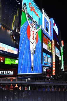 OSAKA, JAPAN - OCT 23: The Glico Man Running billboard and other neon displays on October 23, 2010 in Dotonbori, Osaka, Japan. Dotonbori has many shops, restaurants and colorful billboards. 