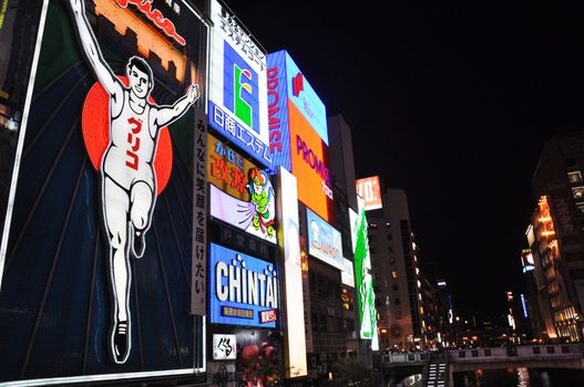 OSAKA, JAPAN - OCT 23: The Glico Man Running billboard and other neon displays on October 23, 2010 in Dotonbori, Osaka, Japan. Dotonbori has many shops, restaurants and colorful billboards. 