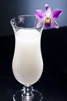 Pina Colada cocktail with nice orchid decoration