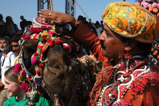 PUSHKAR, INDIA - NOVEMBER 22: Camel and his owner took first place at camel decoration competition at camel mela in Pushkar on November 22,2012 in Pushkar, Rajasthan, India