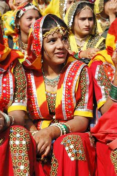 PUSHKAR, INDIA - NOVEMBER 21: Young women  are preparing to perfomance at annual camel fair holiday in Pushkar on November 21,2012 in Pushkar, Rajasthan, India