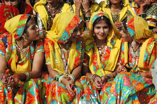 PUSHKAR, INDIA - NOVEMBER 21: Beautiful indian women in traditional rajasthani clothes preparing to dance at  annual camel fair holiday in Pushkar on November 21,2012 in Pushkar, India