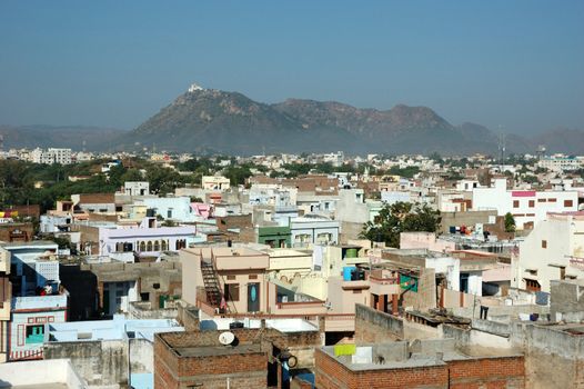 Old roofs of Udaipur with Monsoon Palace (Sajjan Garh Palace) on the hill, Rajasthan, India
