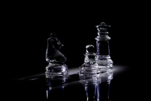 Some chess pieces in the darkness