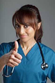 Attractive Indian doctor woman posing in a studio in front of a background