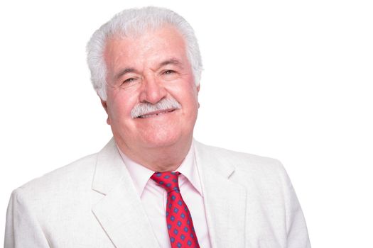 Senior white hair man with a red tie and beige suite smiling satisfied