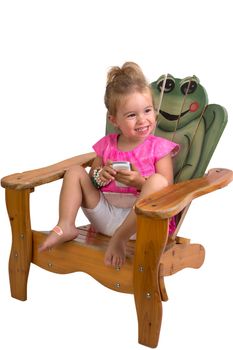 Pretty Young Toddler Showing her happey feelings on a beach chair while holding a cell phone, perhaps she received good news