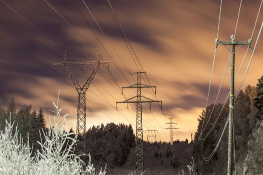 Power lines and yellow clouds at night