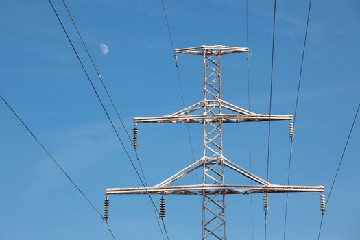 Power lines clear blue sky and moon at winter