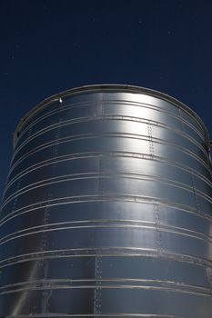 Metallic silo building at night