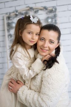 Mom and daughter in the winter holidays New Year and Christmas dresses