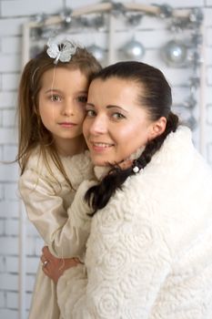 Mom and daughter in the winter holidays New Year and Christmas dresses