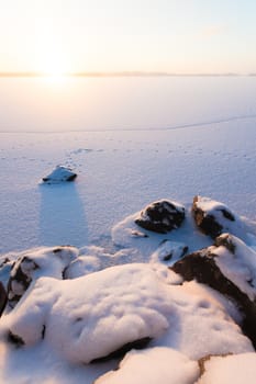 Serene winter morning view to frozen lake