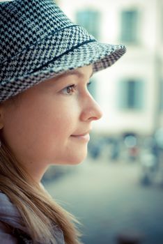 beautiful blonde woman with hat in the city