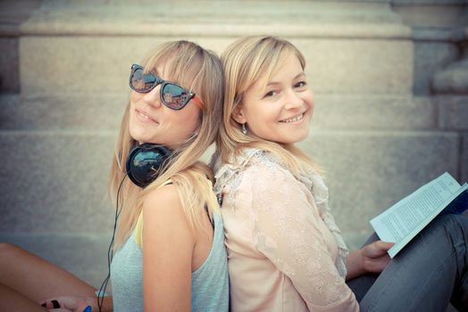 two beautiful blonde woman relaxing in the city