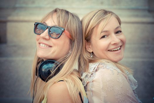 two beautiful blonde woman relaxing in the city