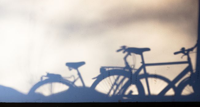 parked bike shadows on wall