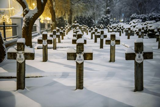 War cemetery in Siedlce, Poland covered with snow at night