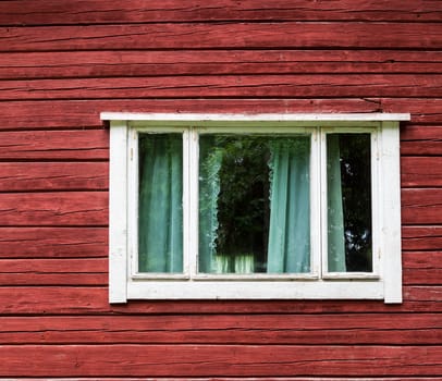 Window in a red wooden house