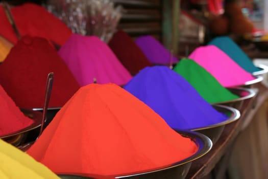 Piles of many colors of tikka powder for sell in india bazaar.