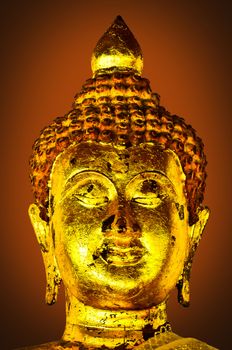 Ancient Buddha face Thailand on brown light