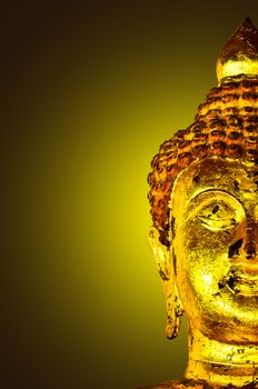 Ancient Buddha face Thailand on yellow light