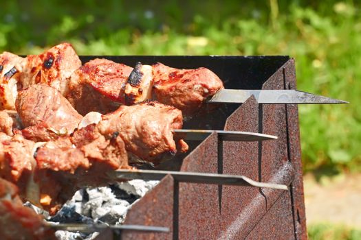 Shashlik (shish kebab) prepared on the metal skewers outdoor