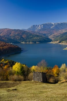 Autumn rural mountain landscape with lake, Romanian Carpathians