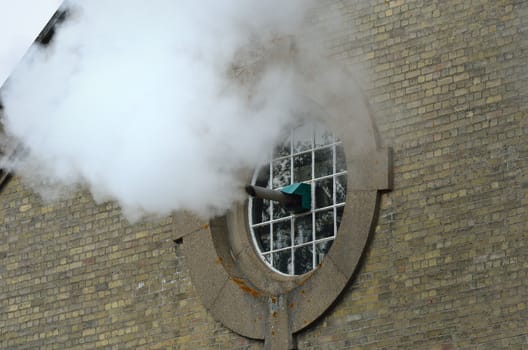 Steam being expelled from brick building
