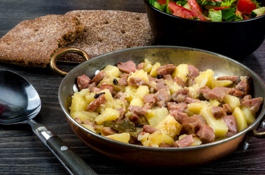 Fried potato with meat and vegetables
