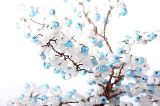 Hand made tree branch decorated with beads isolated. Close up