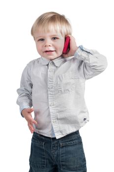 Little cute boy speaking on the pink phone