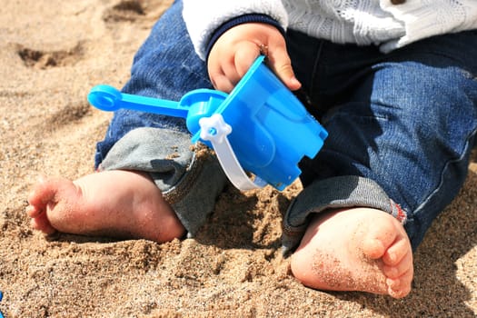 Baby playing on the beach.