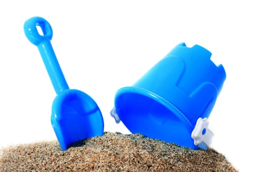 Toys and sand isolated over white.