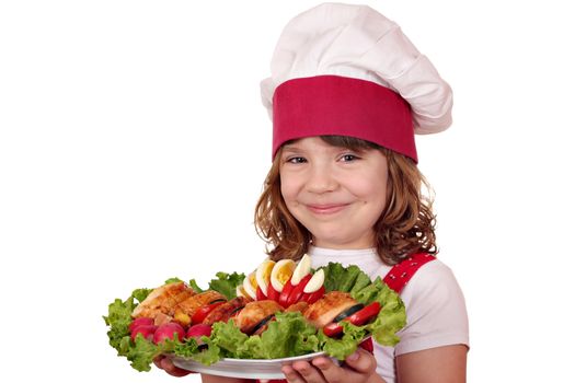 beautiful little girl cook with roasted chicken meat and salad