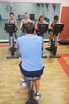 Four women take spinning class at gym