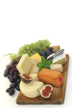 different types of cheese on a wooden board