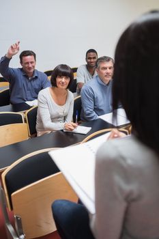 Man asking question in lecture in college