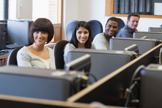 Smiling group in computer class in college
