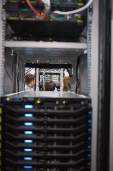 People looking after the servers in a server room in data center