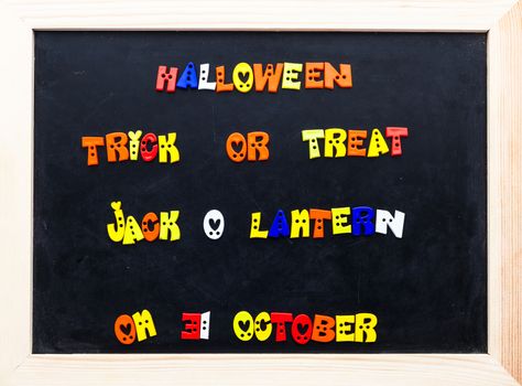 Color halloween words on clip board. words on black board.
