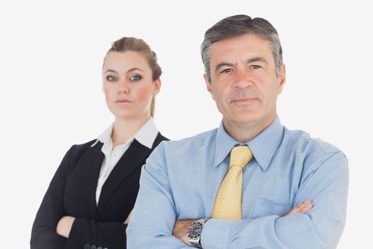 Portrait of confident business people with arms crosssed against white background