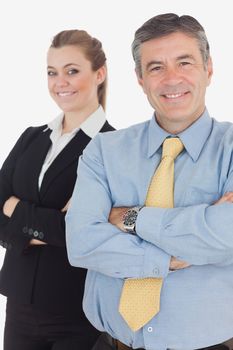 Portrait of happy business people with arms crossed standing against white background