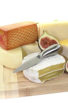 Selection of cheese with knife and fig