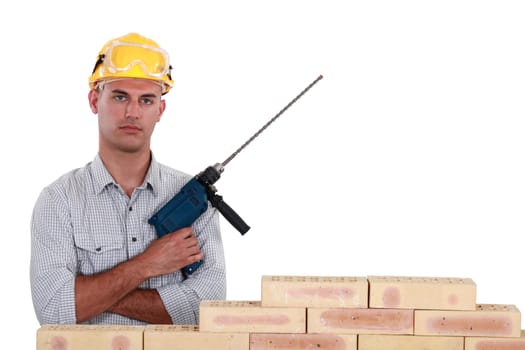A mason holding a drill.
