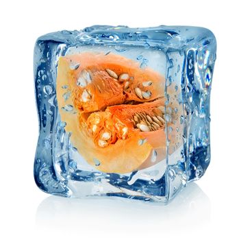 Pumpkin in ice cube isolated on a white background