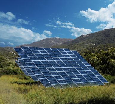 Solar energy panel collectors on sunny countryside landscape