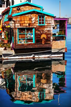 Floating Home Village Brown Houseboat Fisherman's Wharf Reflection Inner Harbor, Victoria Vancouver British Columbia Canada Pacific Northwest.  Close to the center of Victoria, this area has floating homes, boats, piers, and restaurants.